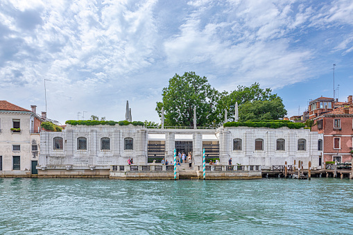 Venice, Veneto, Italy-June 26, 2023; on a sunny summer morning as seen from a pier of the Basilica Di San Giorgio Maggiore. The pier looks like the cab stand for water craft cabs to tour and travel along the canals of Venice.