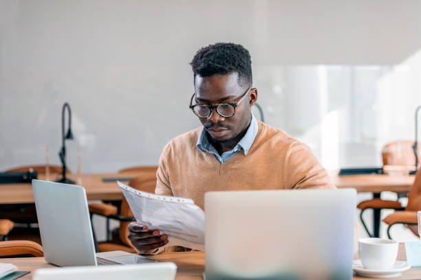 istock Serious young businessman in eyeglasses working on computer 1329000606