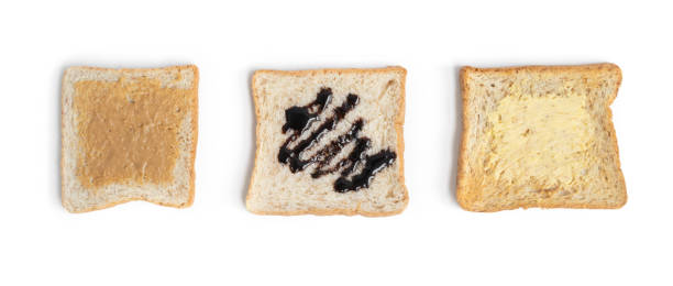 istock Bread with peanut butter isolated on white background. Homemade cooking and baking. Breakfast. Food, toasts, ingredients and bakery supplies in kitchen, bakery preparation. 1329000661