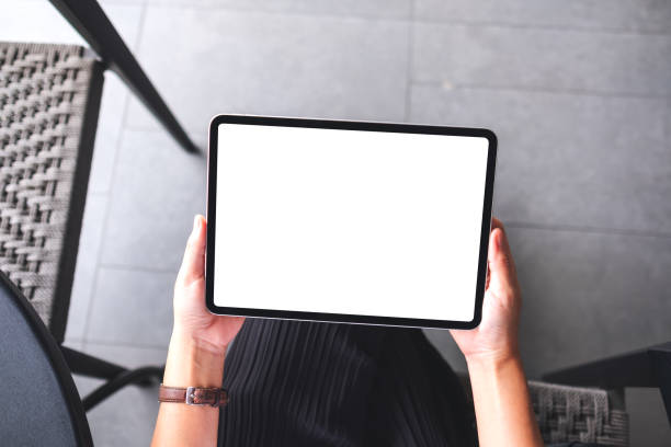 istock a woman holding digital tablet with blank white desktop screen 1329000668