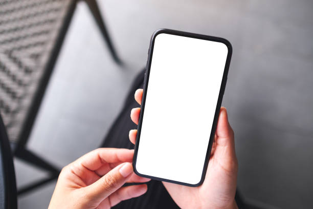 istock a woman holding mobile phone with blank white desktop screen 1329000683
