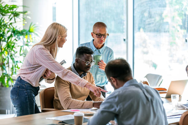 istock Mature and Young business people in office 1329000890