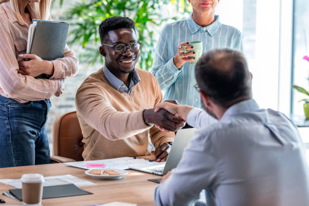 istock Business people shaking hands in office 1329000901