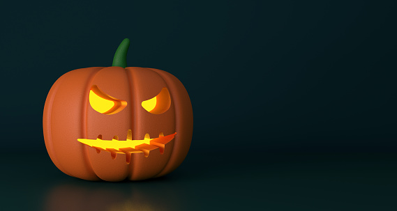 Halloween pumpkin with light on dark background. Halloween Background Concept.