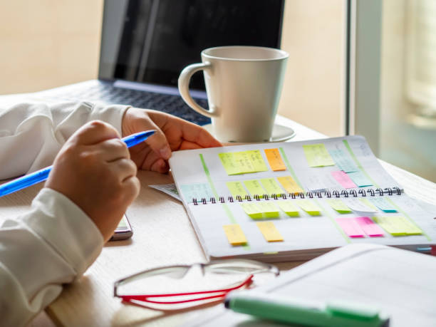 istock businesswoman's hands organizing agenda with sticky notes 1329003934