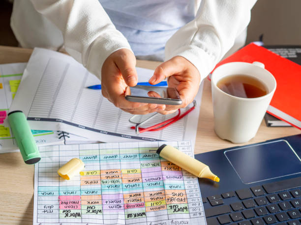 istock young woman using a smartphone to scan a planning calendar 1329003938