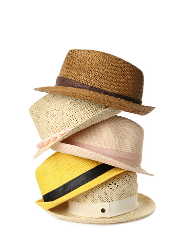 Many different stylish straw hats on white background
