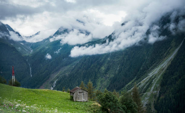 an alpine hut in the valley during a colorful sunrise