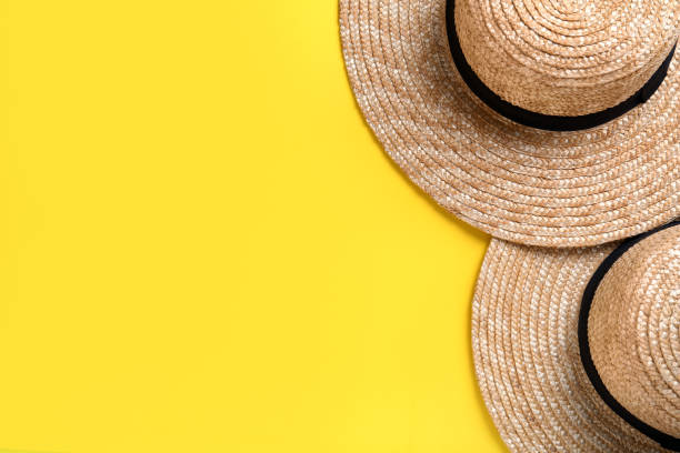 istock Stylish straw hats on yellow background, flat lay. Space for text 1329005005