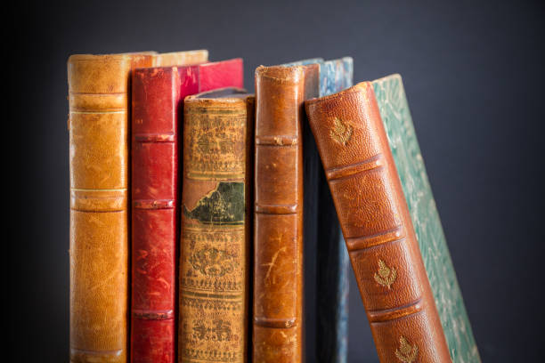 istock Row of old books on dark background 1329005314