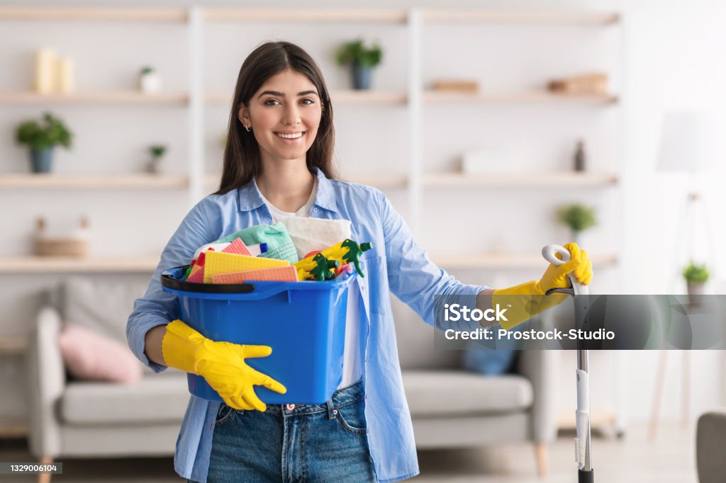 Cheerful Young Housewife Holding Bucket With Cleaning Supplies Stock Photo  - Download Image Now - iStock