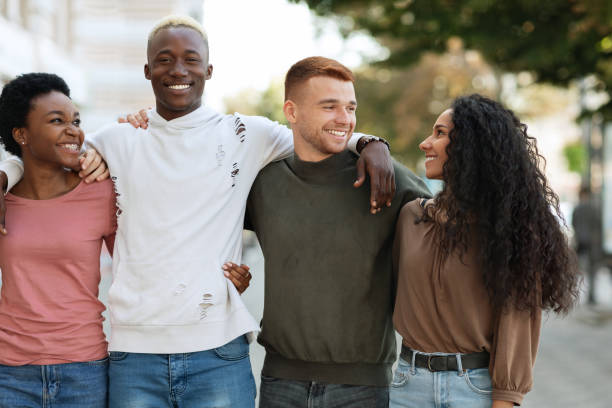 istock International group of students hugging while standing on the street 1329006134