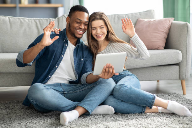 istock Video Call. Interracial Couple Using Digital Tablet For Web Conference With Friends 1329006204