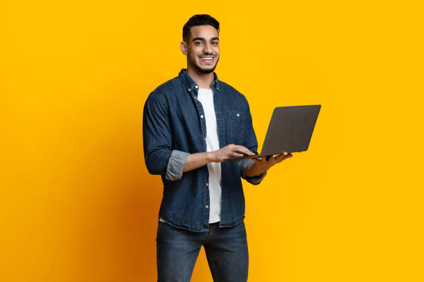 istock Handsome arab guy enjoying his new modern laptop 1329007473