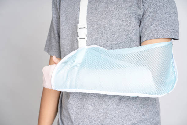 istock Plastered arm, broken arms at teenagers on a white background. 1329007981
