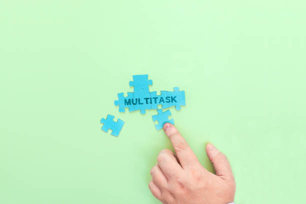 istock Businessman connecting puzzle pieces with the word Multitask 1329008121