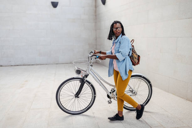 istock Young woman going to work with bicycle 1329008179