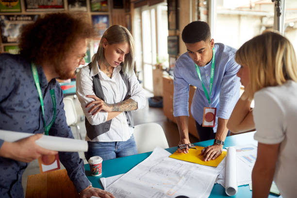 istock A group of young creative colleagues is analyzing some project drafts at work in the office 1329008858