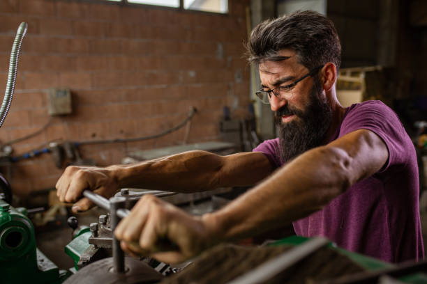 istock Dedicated turner worker tighten the lathe machine 1329010085