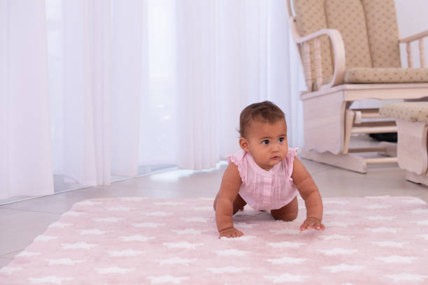 baby crawling on the floor. - baby tile crawling tiled floor imagens e fotografias de stock
