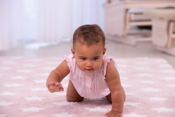 baby crawling on the floor. - baby tile crawling tiled floor imagens e fotografias de stock