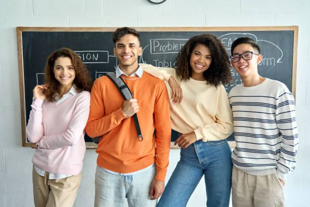 istock Four multiracial business startup coworkers standing on black board background. 1329013207