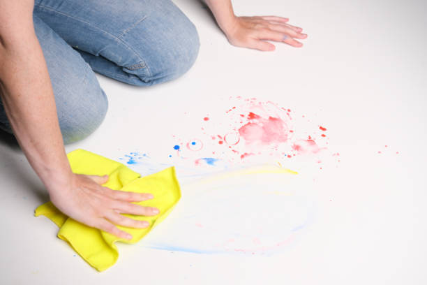 istock Hands of kneeling person are rubbing dirty white floor using microfiber duster 1329014325