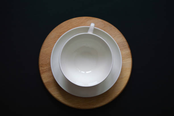 istock White tea cup on a wooden stand on a black background 1329015417