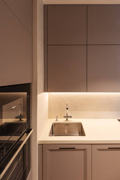istock A part of modern kitchen interior with sink, oven and grey cupboard 1329015847