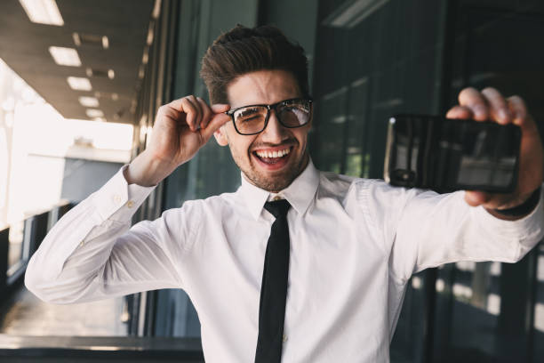 istock Business man near business center using mobile phone take a selfie. 1329016438