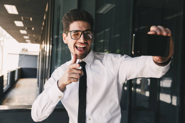 istock Business man near business center using mobile phone take a selfie. 1329016541
