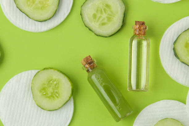 istock Cosmetics care with cucumber extract and fresh cucumber on a bright green background. spa. beauty. 1329019191
