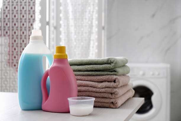 istock Stack of folded towels and detergents on white table in bathroom 1329020501