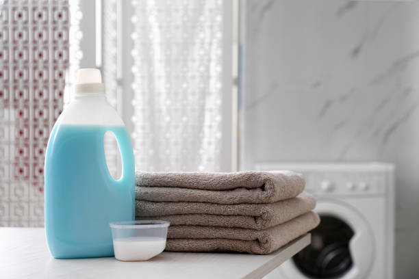 istock Stack of folded towels and detergents on white table in bathroom 1329020559