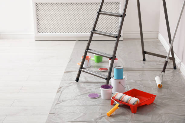 istock Different paints and decorator's tools near ladder indoors, space for text 1329021051