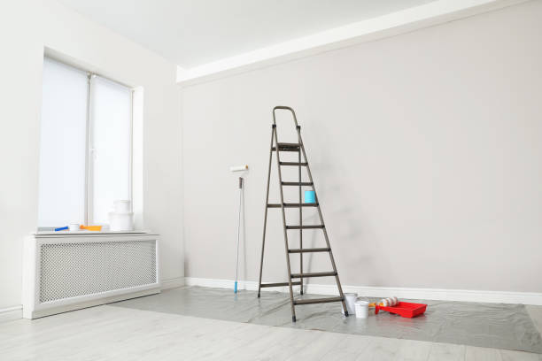 istock Decorator's tools and ladder near white wall indoors 1329021163