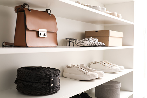 Storage rack with stylish women's shoes and accessories indoors