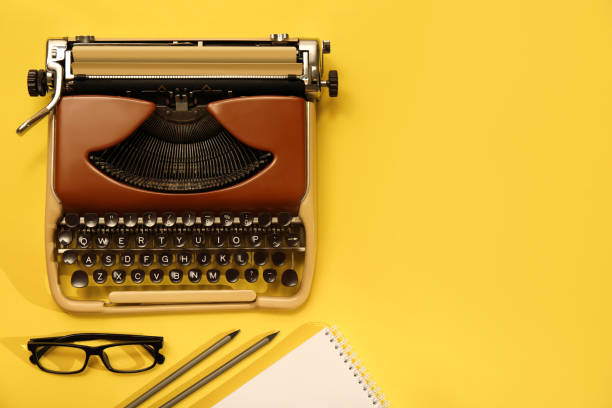 istock Vintage typewriter, glasses and stationery on yellow background, flat lay. Space for text 1329021721
