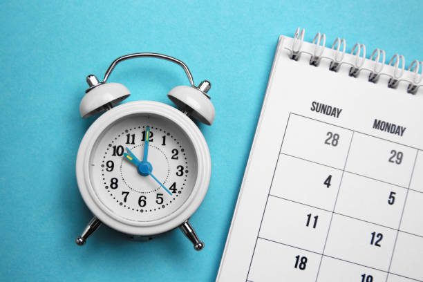 istock Alarm clock and calendar on light blue background, flat lay. Reminder concept 1329021762