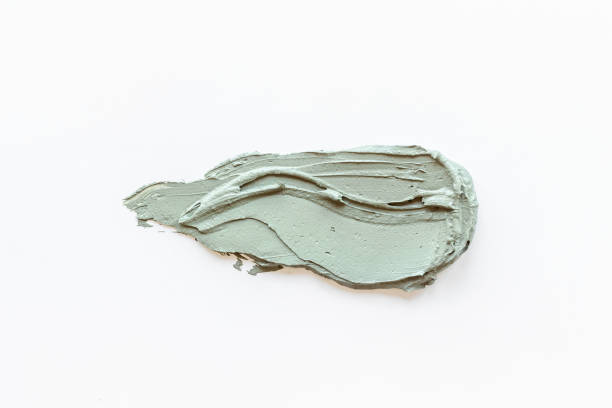 istock Cosmetic blue clay mask isolated on white background 1329024100