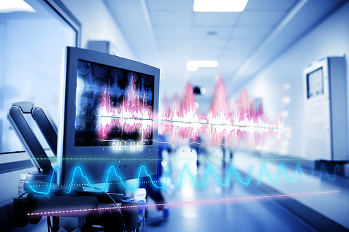 Concepto de tecnología médica con un holograma de curvas y gráficos de datos sobre el fondo de los equipos dentro del hospital photo