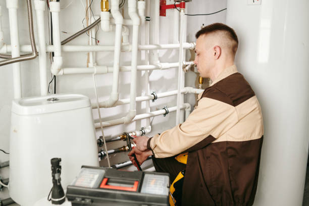 istock Young man in workwear fixing details of pipe 1329032148