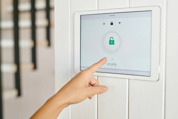 istock Hand of young woman pointing at display with security symbol 1329032181