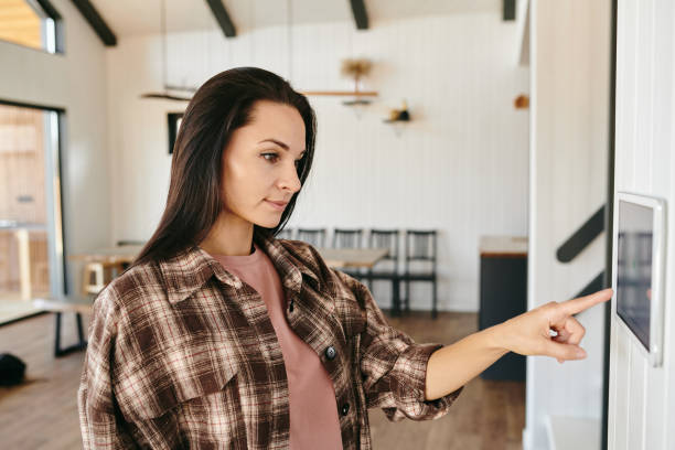 istock Young brunette female pointing at display on the wall 1329032185