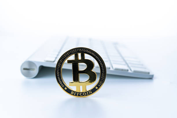 istock Trade bitcoin. Golden Bit Coin virtual cryptocurrency or blockchain technology. Gold Crypto currency BTC Bitcoin with keyboard on white background. Block chain, network connect concept. 1329032480