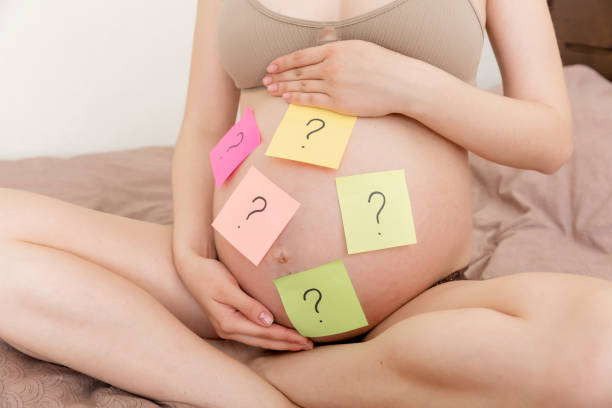 istock Pregnant woman belly with question mark. Pregnancy and thinking problem 1329033697