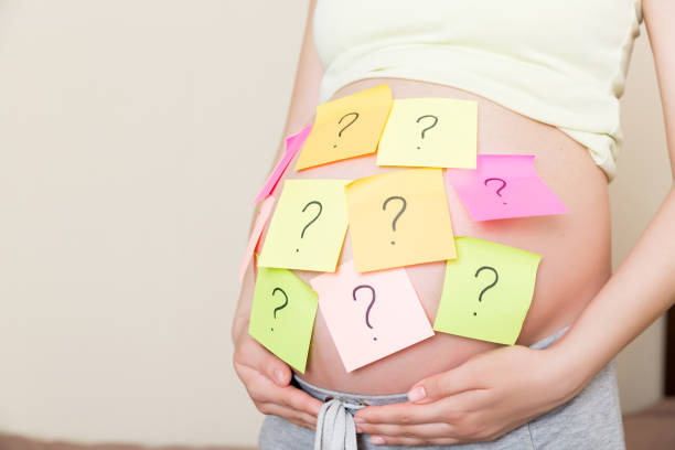 istock Pregnant woman belly with question mark. Pregnancy and thinking problem 1329033705