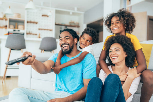 istock Family watching television 1329034859