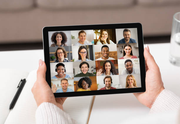 istock Unrecognizable Woman Holding Digital Tablet With Group Video Chat Interface On Screen 1329036457
