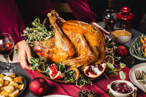 istock Woman serving Christmas turkey on table 1329036840